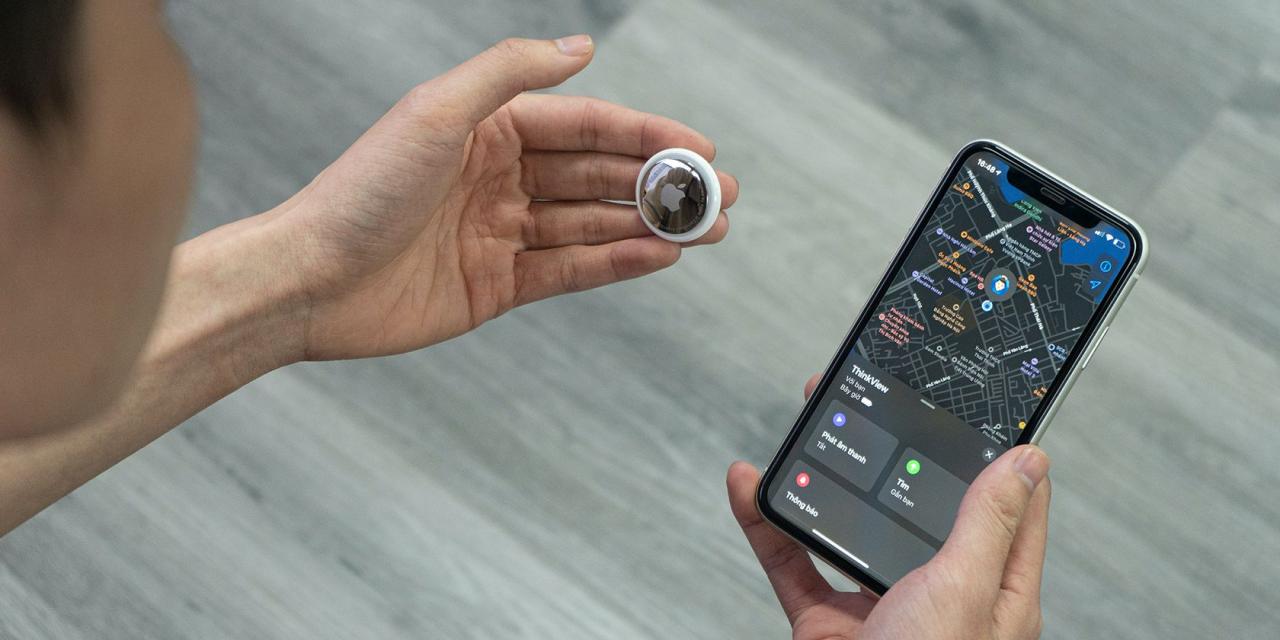 Man holding an AirTag and an iPhone