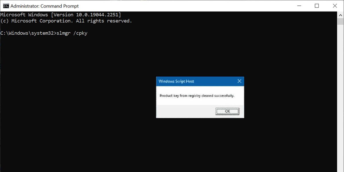 a command prompt window with a confirmation window of product key clear from registry