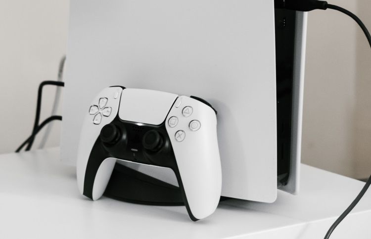 PS5 on white table and controller